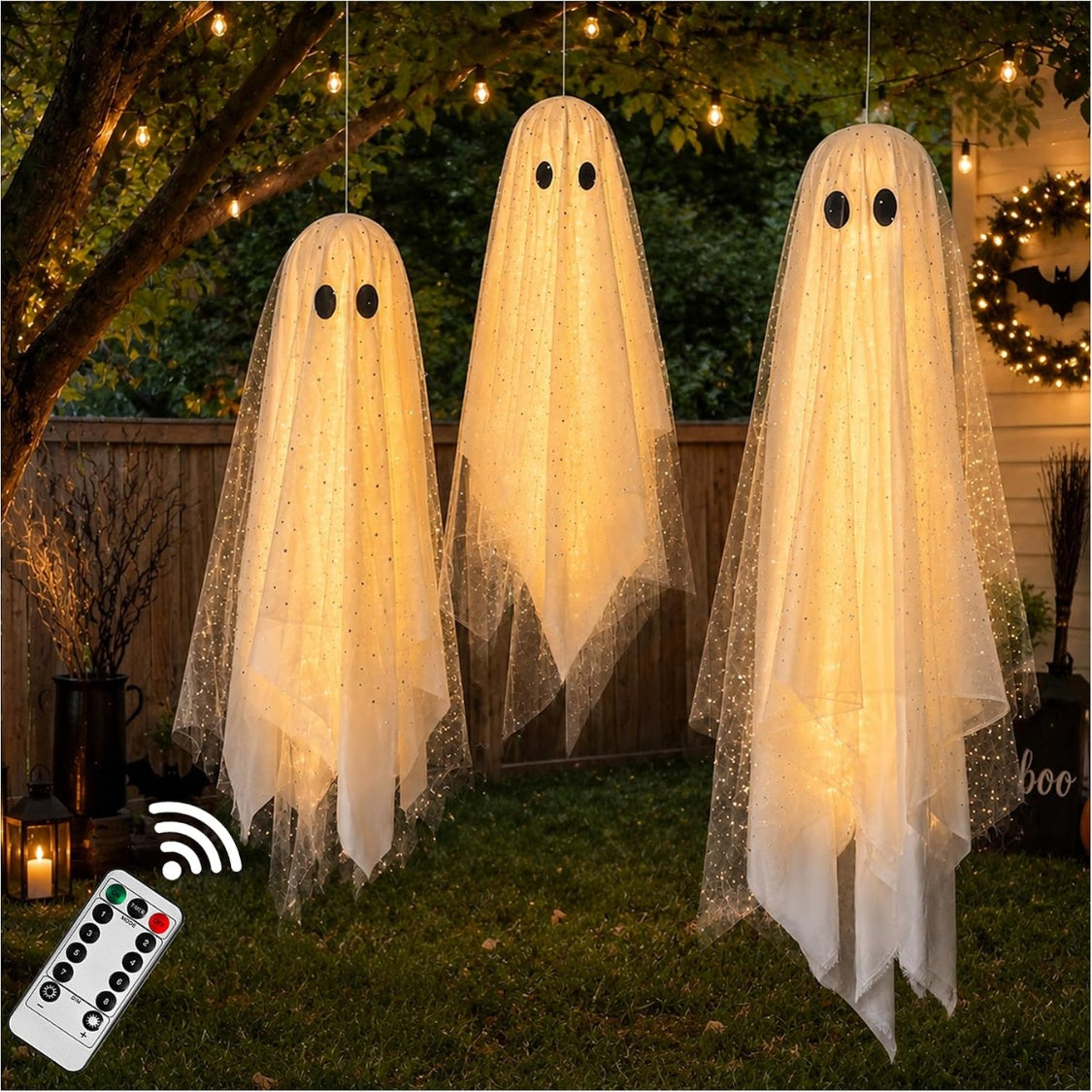 A size guide showing three assembled hanging sequined ghost decorations in a line. The largest ghost is marked as 43 inches tall, and the two smaller ghosts are marked as 31 inches tall, shown hanging over a bed with pumpkins below.