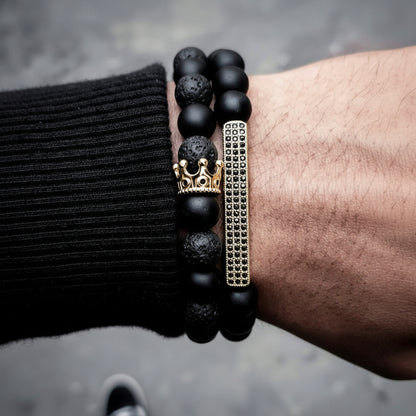 Men's black frosted stone and volcanic stone beaded bracelet with crown and rhinestone details
